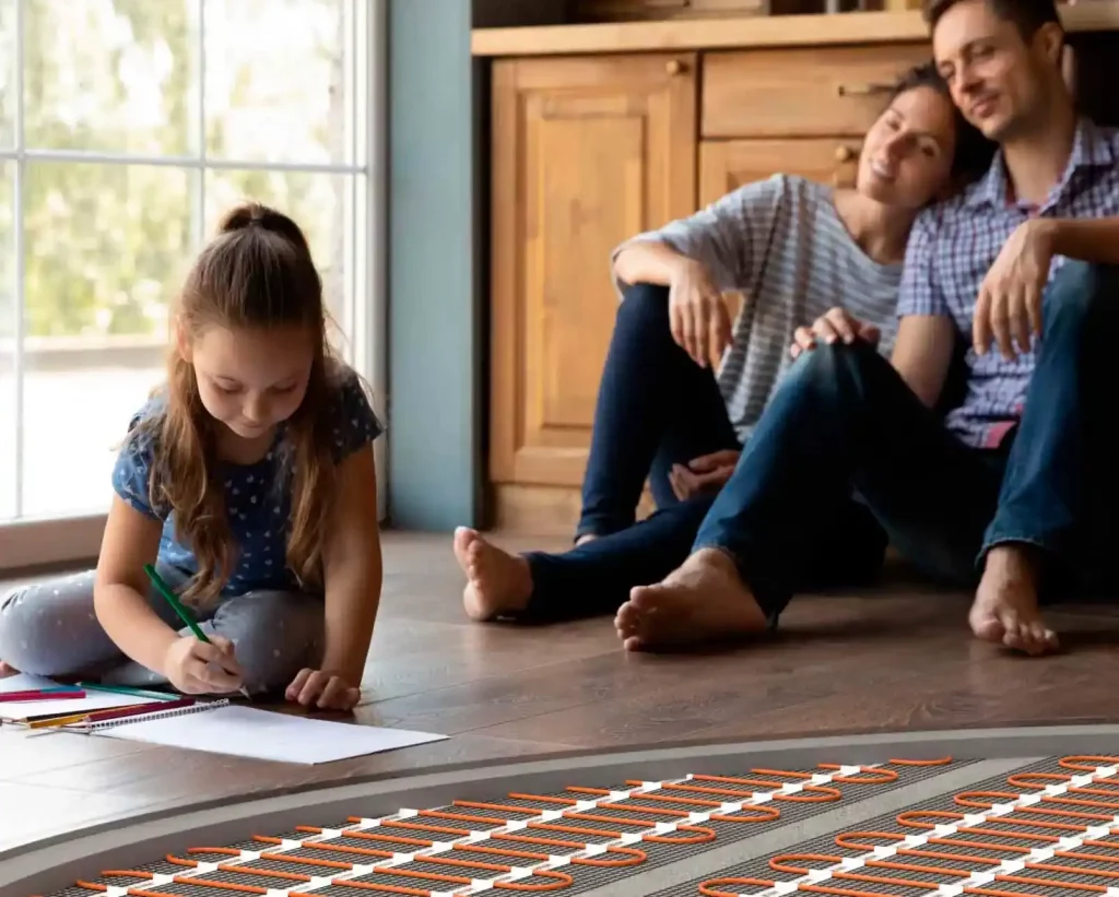 Family enjoying warm floor with visible underfloor heating elements in cozy room with WARM-ON branding