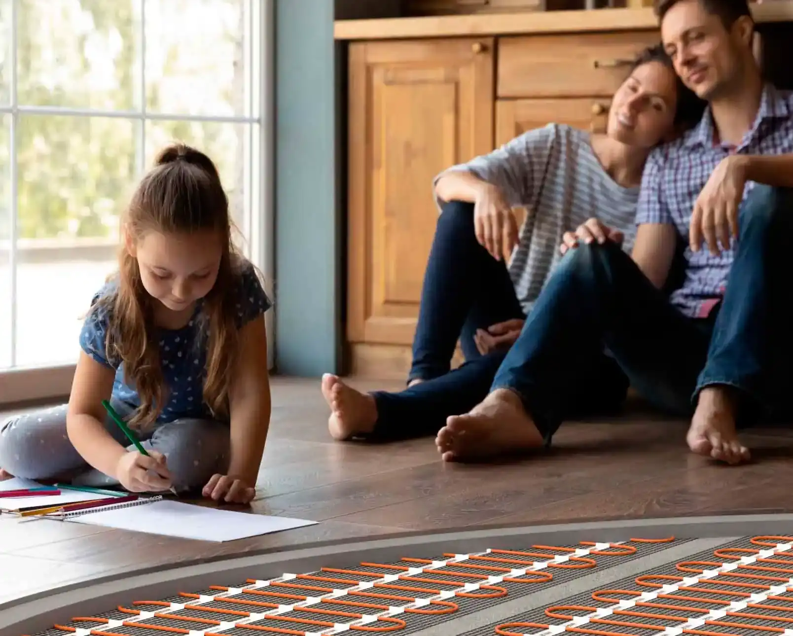 Family enjoying warm floor with visible underfloor heating elements in cozy room with WARM-ON branding